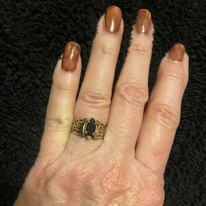 10 karat gold filigree band with a marquis sapphire